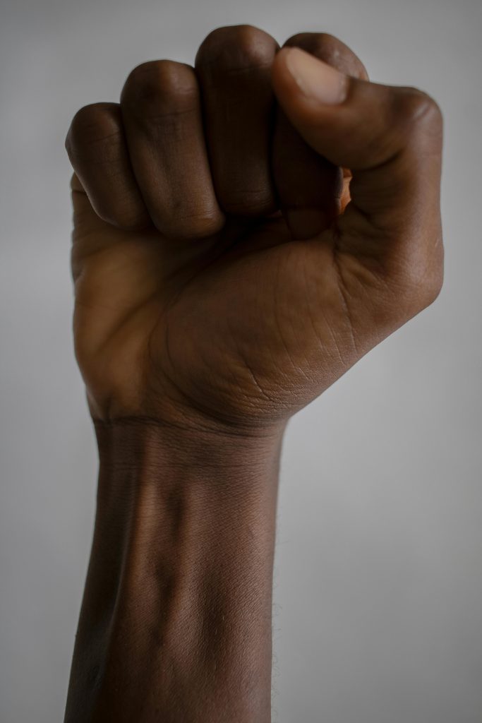 Black fist making a stance against social justice